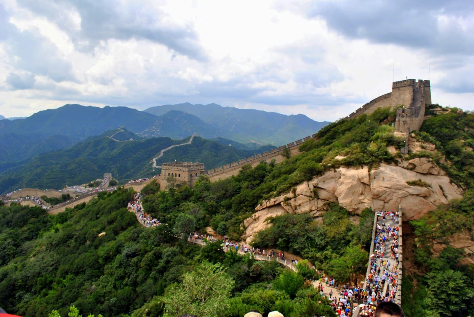 The Great Wall winding over green mountain ridges