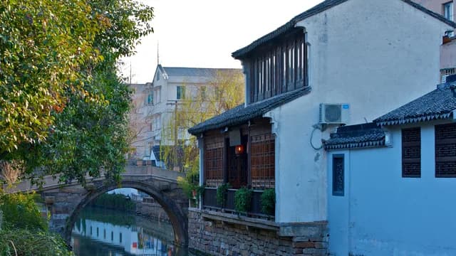 A stone bridge and canal-side houses along Pingjiang Road in Suzhou