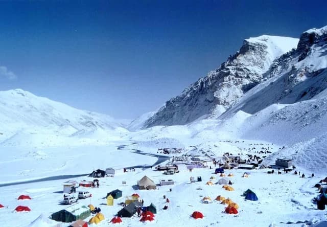 Tents beneath snowy mountains at Everest Base Camp