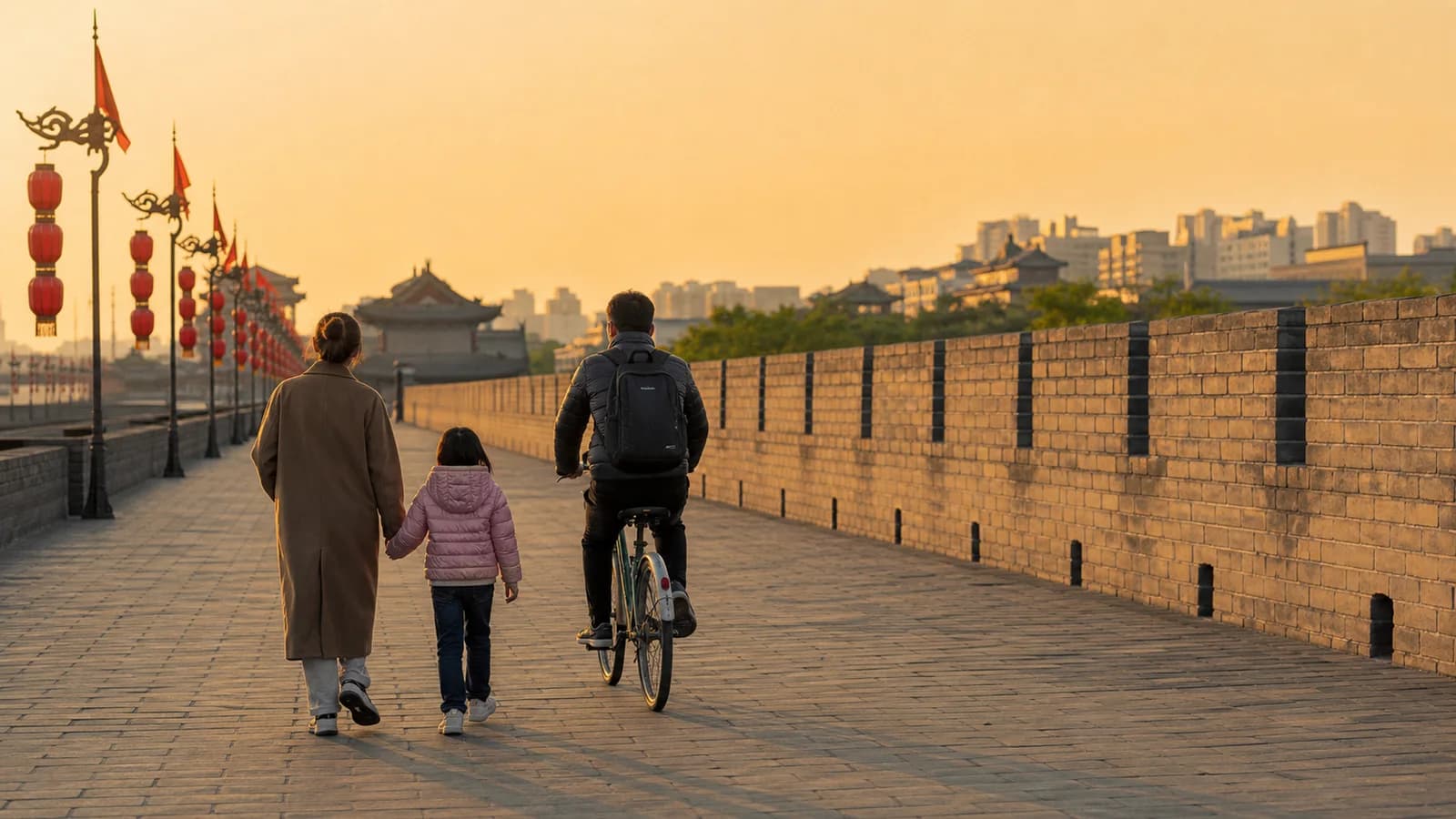 A family exploring Xi’an’s ancient city wall at golden hour