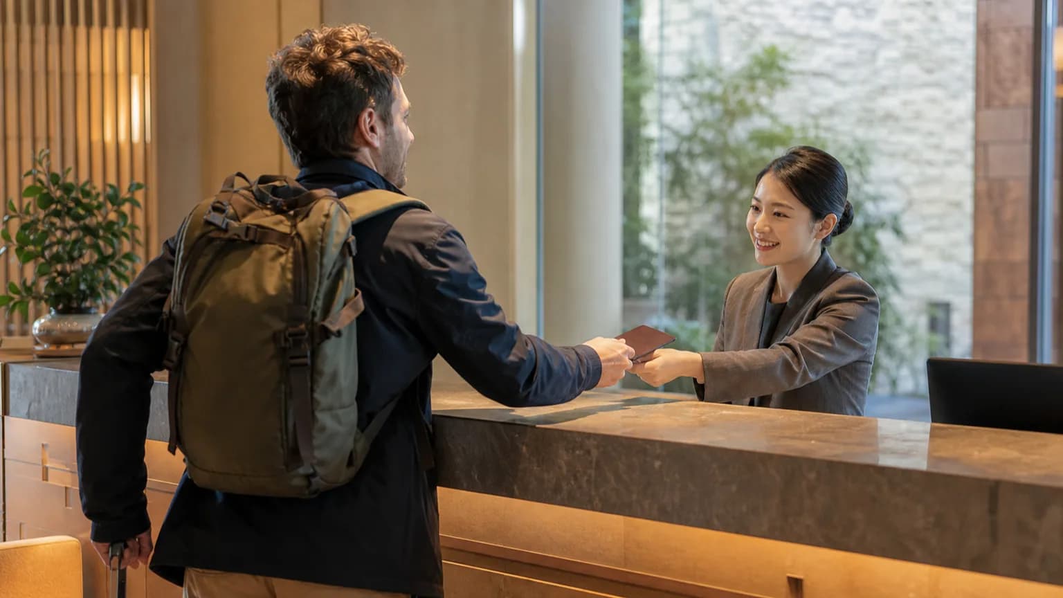 International traveler checking in at a contemporary hotel reception in China