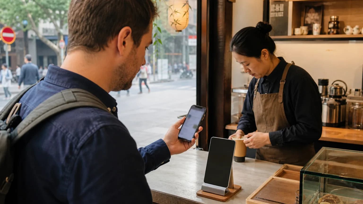 Traveler making a contactless mobile payment at a small shop in China
