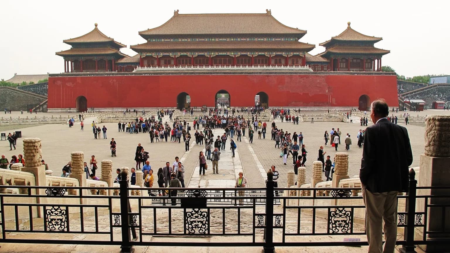 Visitors crossing a Forbidden City courtyard toward the Meridian Gate
