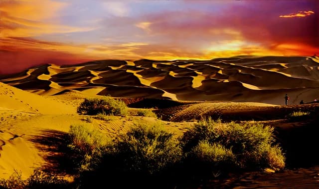 Sunset across the dunes of Kumtag Desert